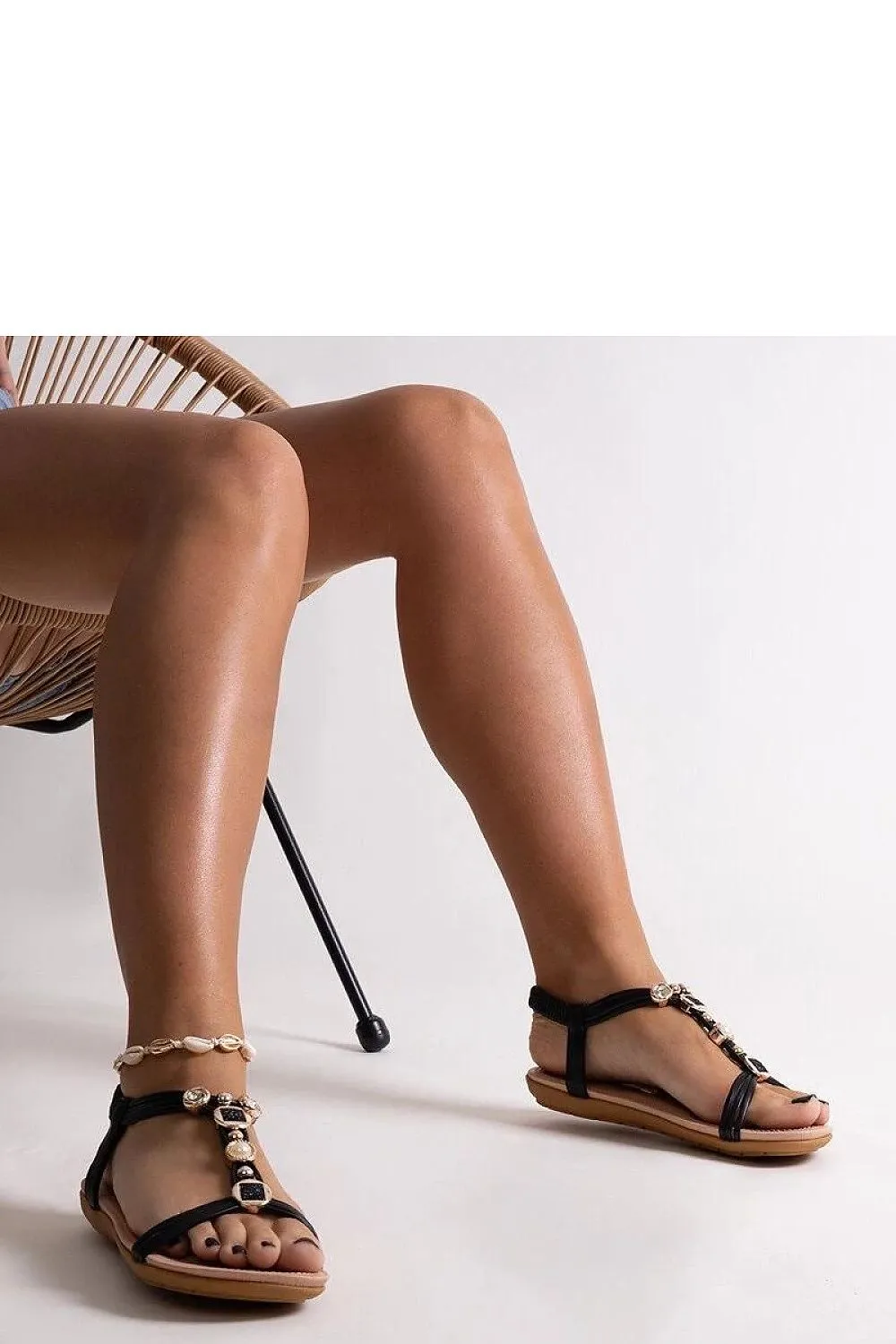 Black sandals with gold embellishments